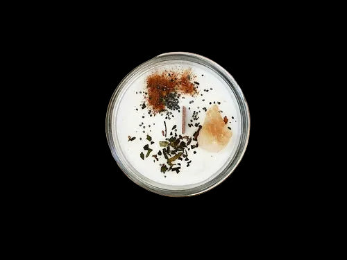 Candle in a glass jar with decorative elements on a wooden board