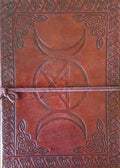 A reddish-brown leather journal with embossed Celtic knotwork borders, a central pentagram and moon symbol, and a cord tie closure.