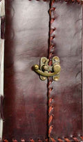 Brown leather journal with brass latch on a white background
