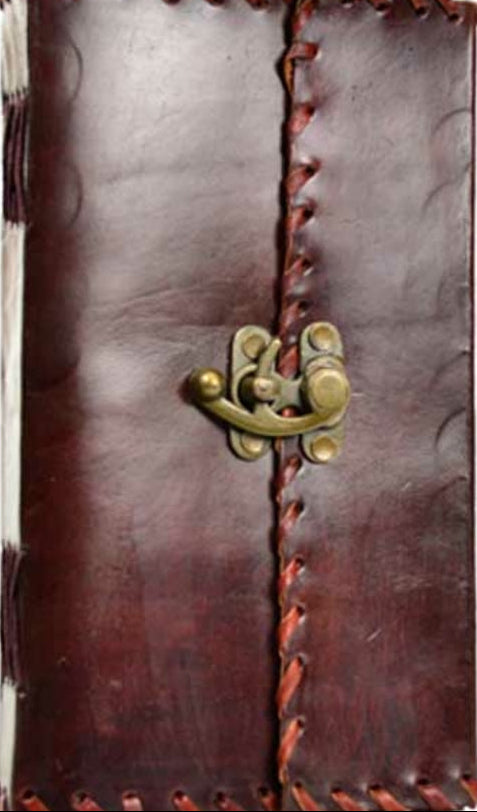 Brown leather journal with brass latch on a white background