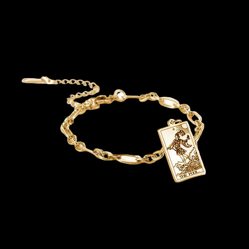 Gold bracelet with a tarot card charm on a white background