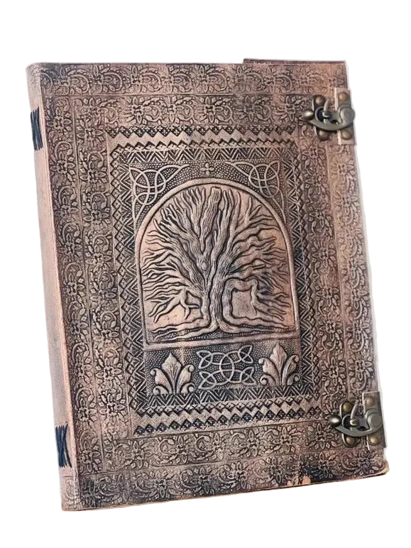 A decorative embossed book or journal with a tree of life design on the cover