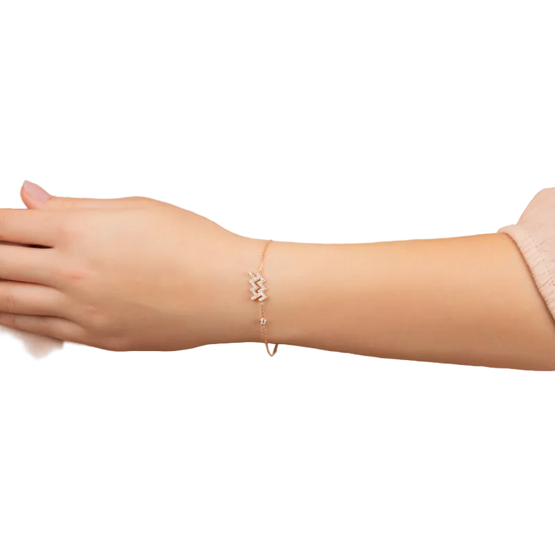 Aquarius zodiac bracelet in rose gold with white zircon detail on wrist
