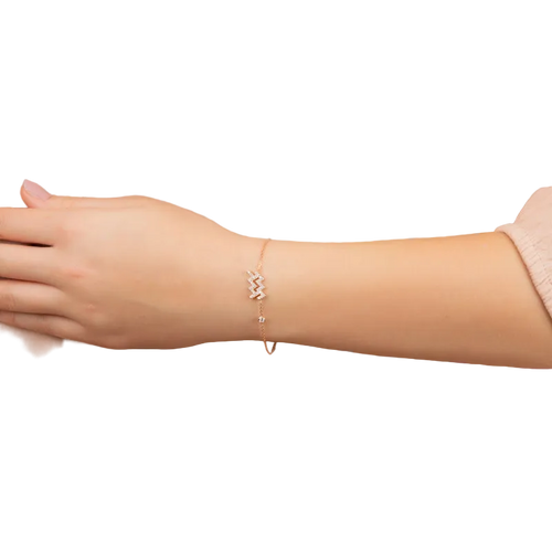 Aquarius zodiac bracelet in rose gold with white zircon detail on wrist